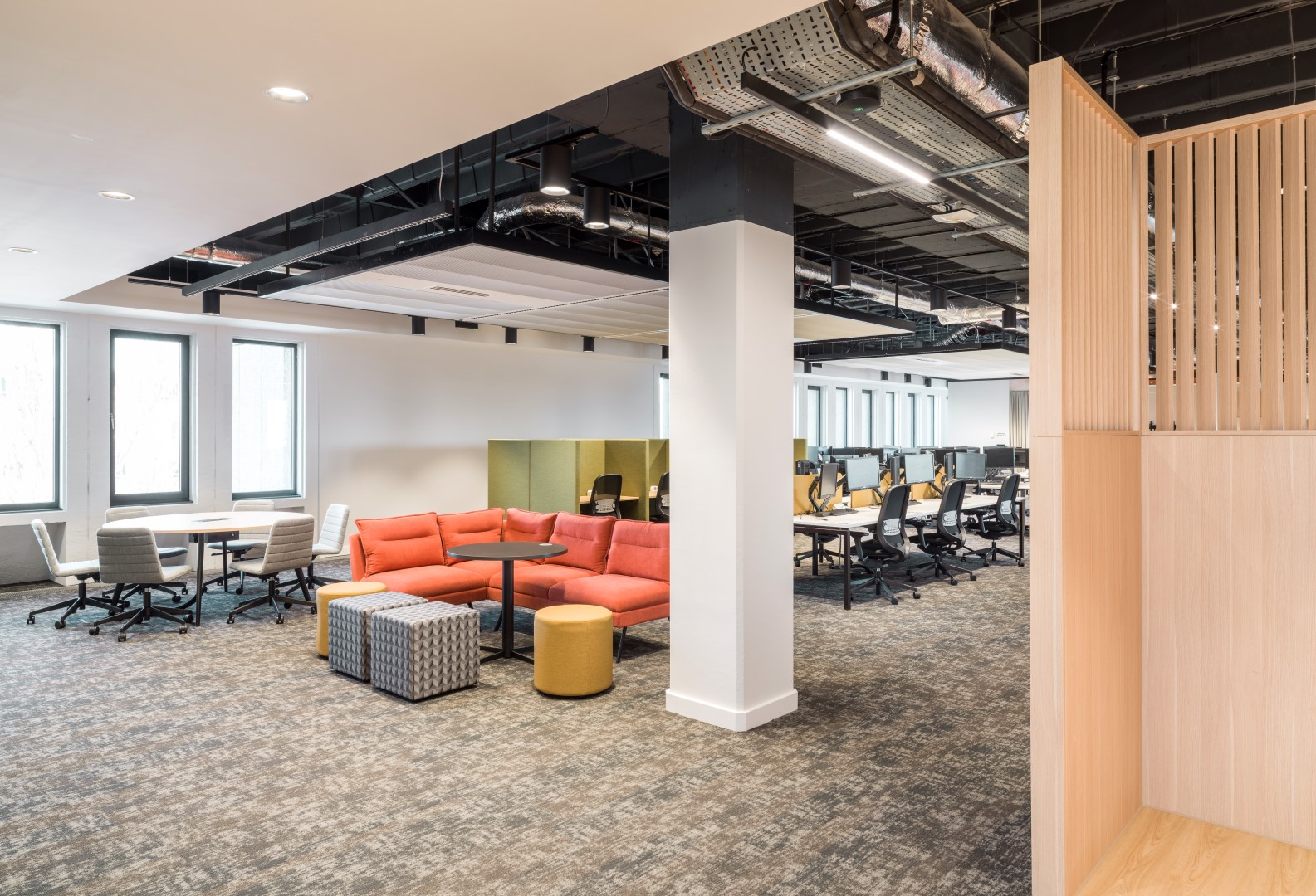 interior of refurbished office building showing collaborative meeting nook